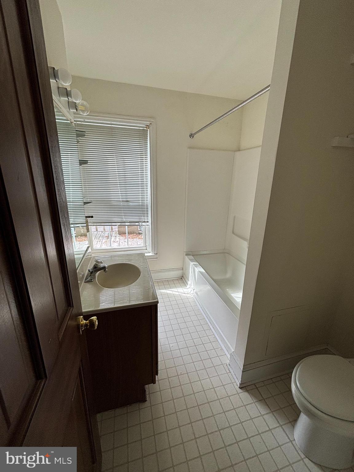 5 South State Street Dover, DE 19901 - Photo 18 of 20 a bathroom with a granite countertop sink toilet and shower
