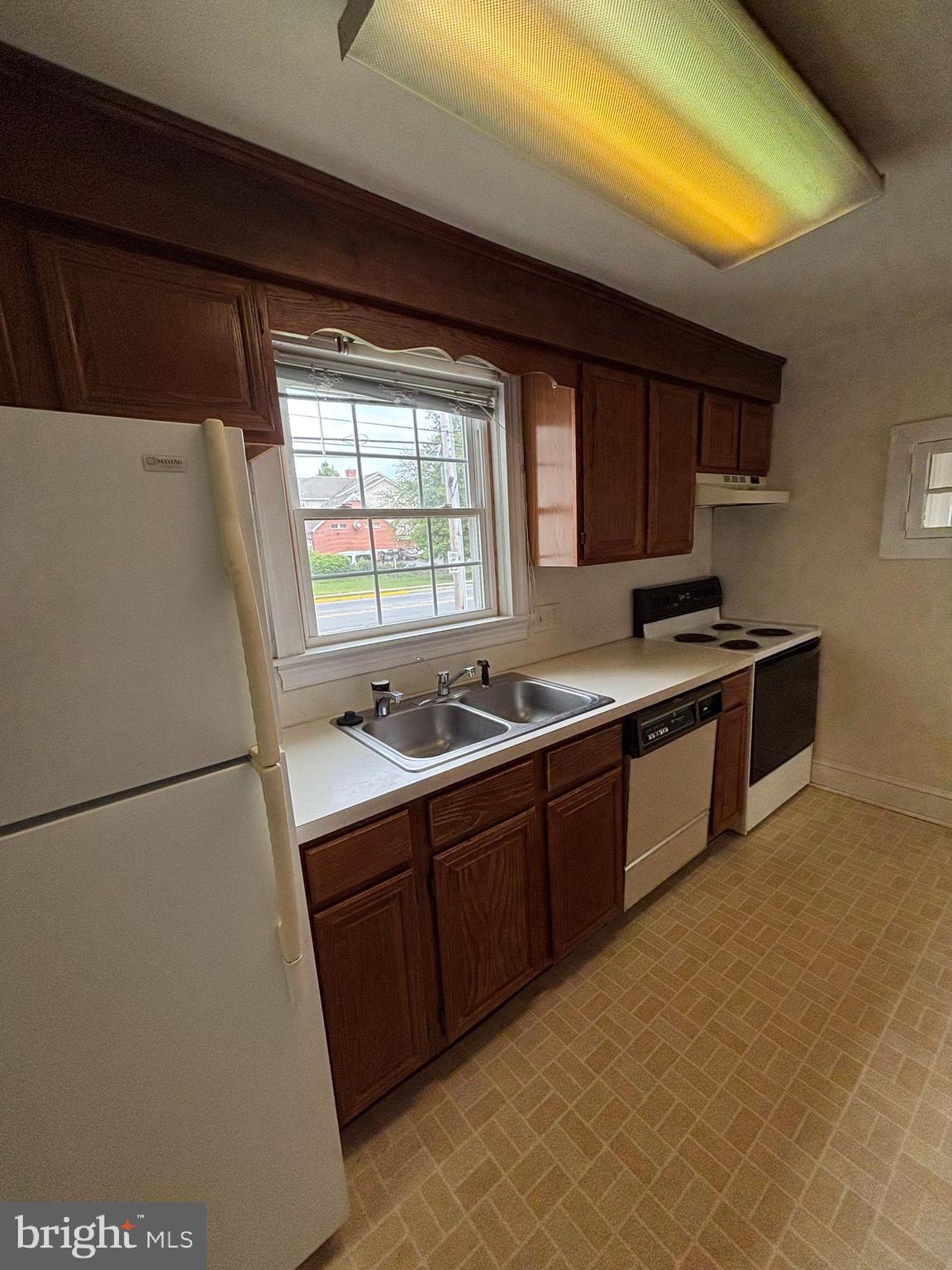 5 South State Street Dover, DE 19901 - Photo 7 of 20 a kitchen with stainless steel appliances granite countertop a sink stove and refrigerator