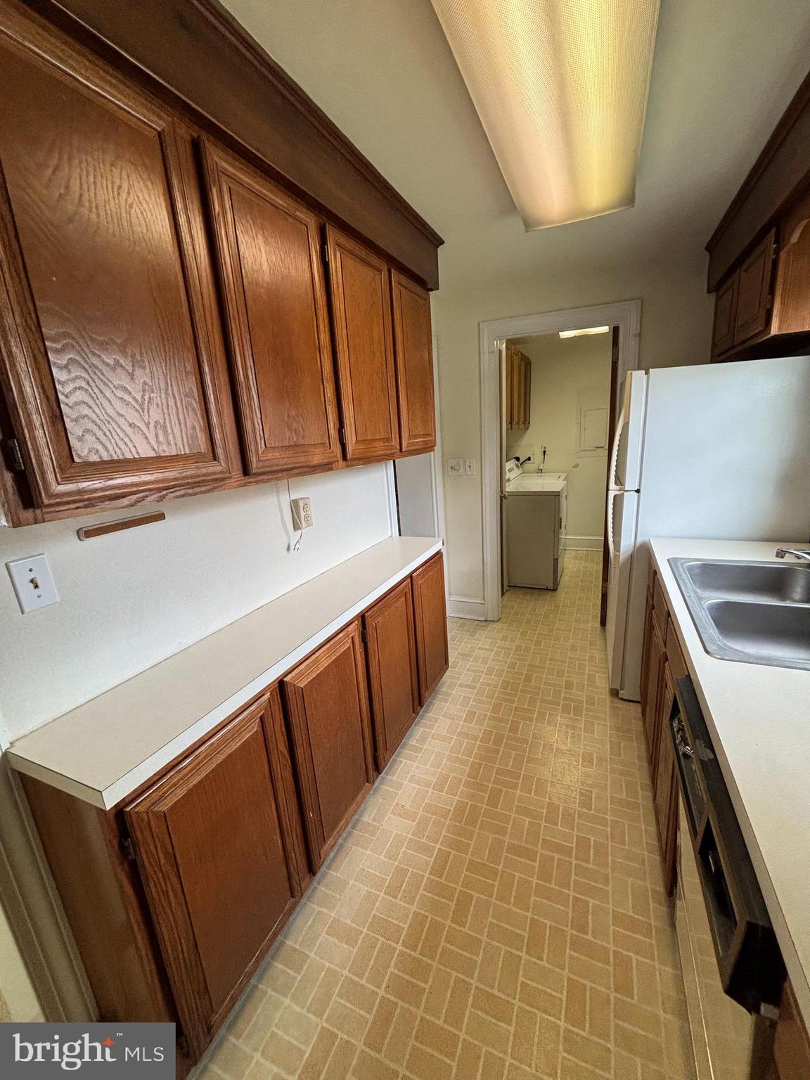 5 South State Street Dover, DE 19901 - Photo 8 of 20 a kitchen with wooden cabinets and a stove top oven