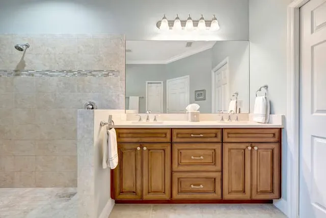a spacious bathroom with a tub sink and mirror