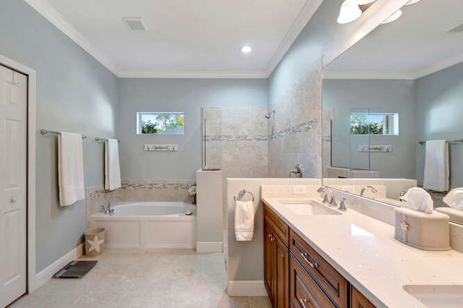 636 Gossamer Wing Way Sebastian, FL 32958 - Photo 14 of 34 a spacious bathroom with a tub sink and mirror