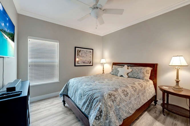 636 Gossamer Wing Way Sebastian, FL 32958 - Photo 16 of 34 a bedroom with a bed a chandelier and a window