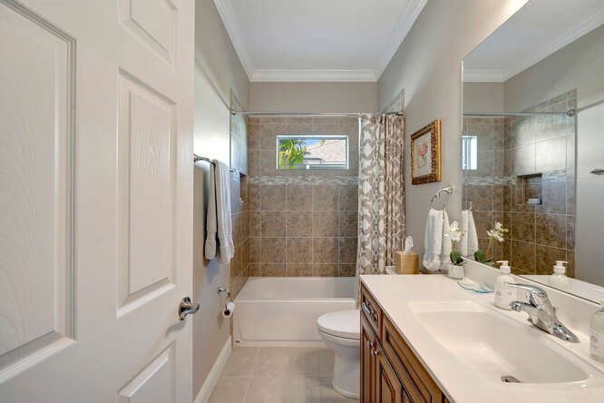 636 Gossamer Wing Way Sebastian, FL 32958 - Photo 17 of 36 a bathroom with a sink a toilet and shower
