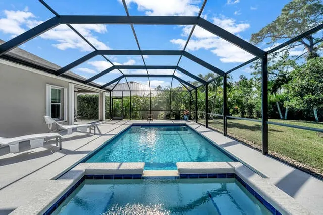 a view of a house with backyard and a patio