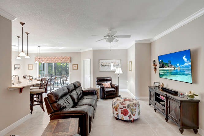 636 Gossamer Wing Way Sebastian, FL 32958 - Photo 5 of 34 a living room with furniture and a flat screen tv