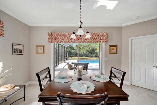 636 Gossamer Wing Way Sebastian, FL 32958 - Photo 10 of 34 a view of a dining room with furniture wooden floor and a chandelier