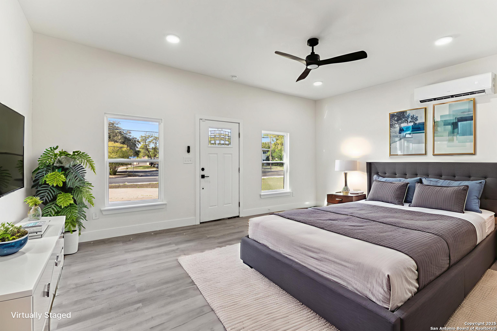 519 Jackson Keller Road San Antonio, TX 78216 - Photo 13 of 40 a spacious bedroom with a bed and a window