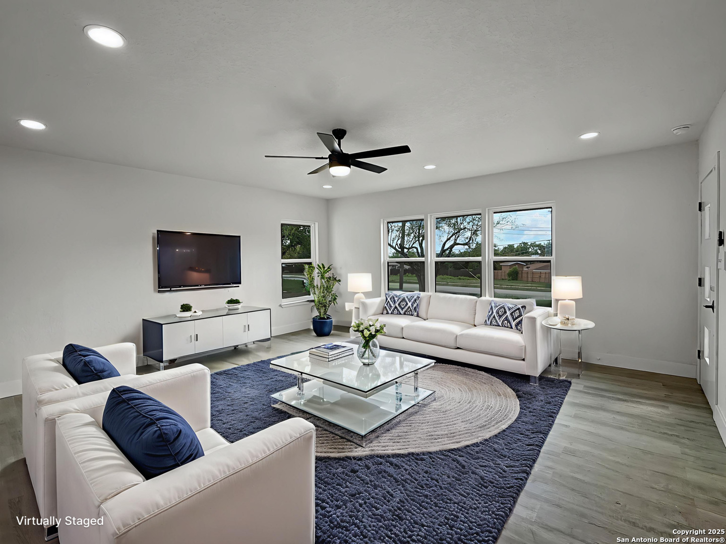519 Jackson Keller Road San Antonio, TX 78216 - Photo 17 of 40 a living room with furniture a flat screen tv and a large window