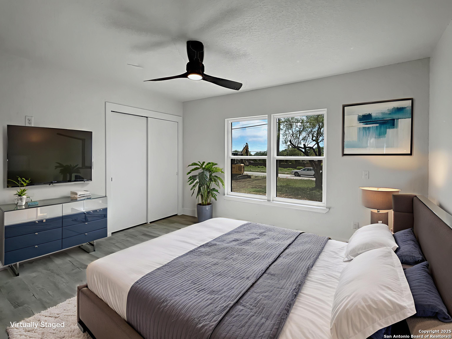 519 Jackson Keller Road San Antonio, TX 78216 - Photo 23 of 40 a bedroom with a bed and a flat screen tv