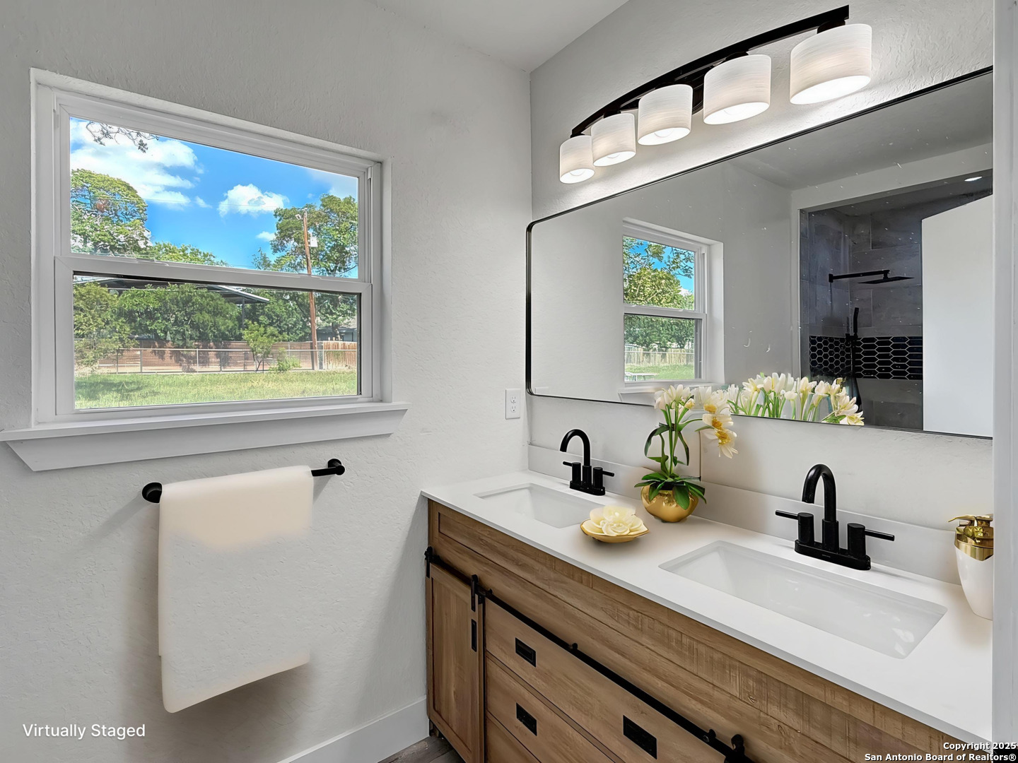 519 Jackson Keller Road San Antonio, TX 78216 - Photo 25 of 40 a bathroom with a sink and a mirror