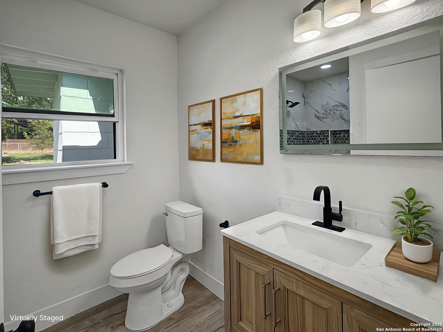 519 Jackson Keller Road San Antonio, TX 78216 - Photo 26 of 40 a bathroom with a toilet sink and mirror