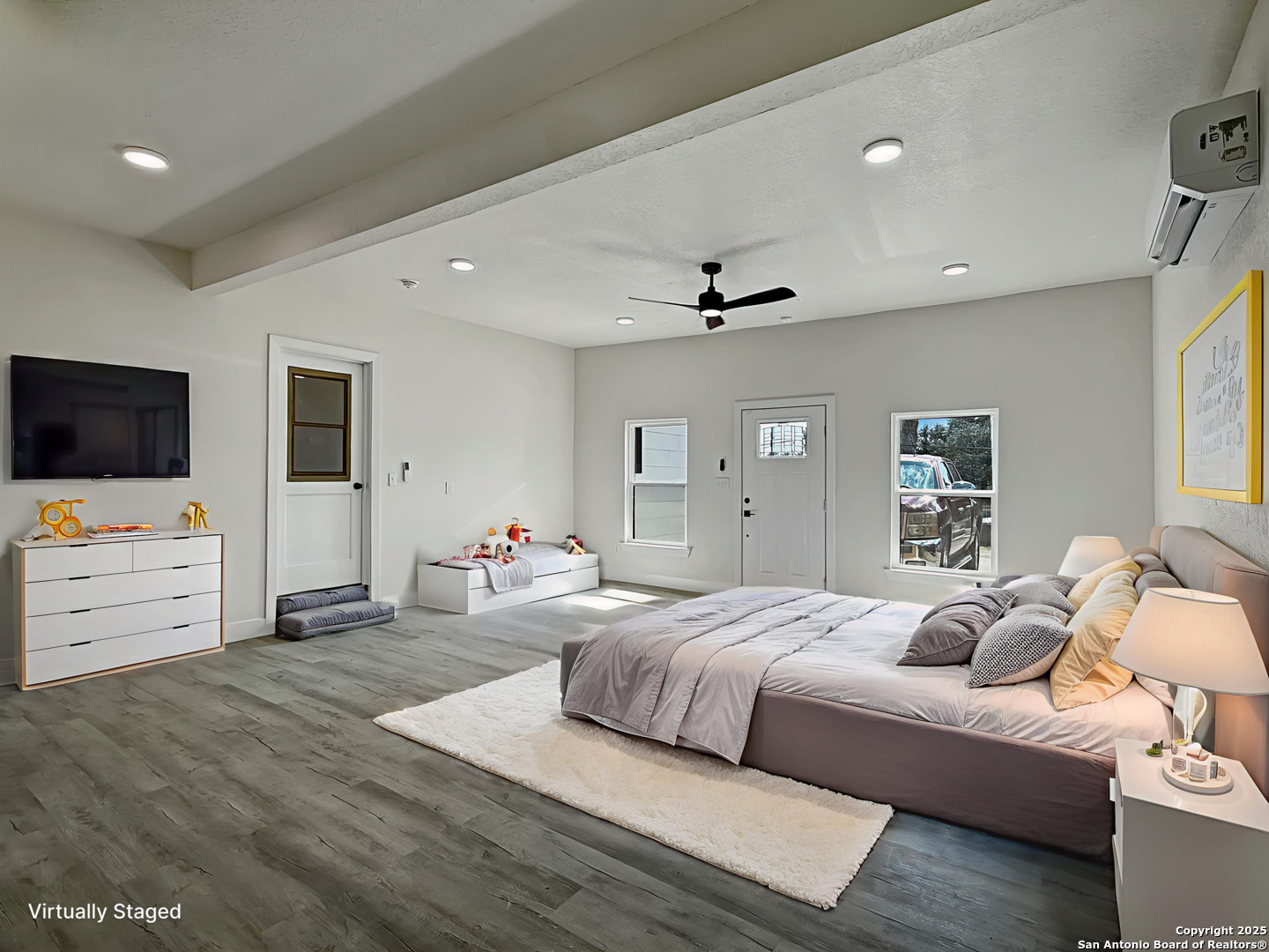 519 Jackson Keller Road San Antonio, TX 78216 - Photo 30 of 40 a bedroom with furniture and flat screen tv