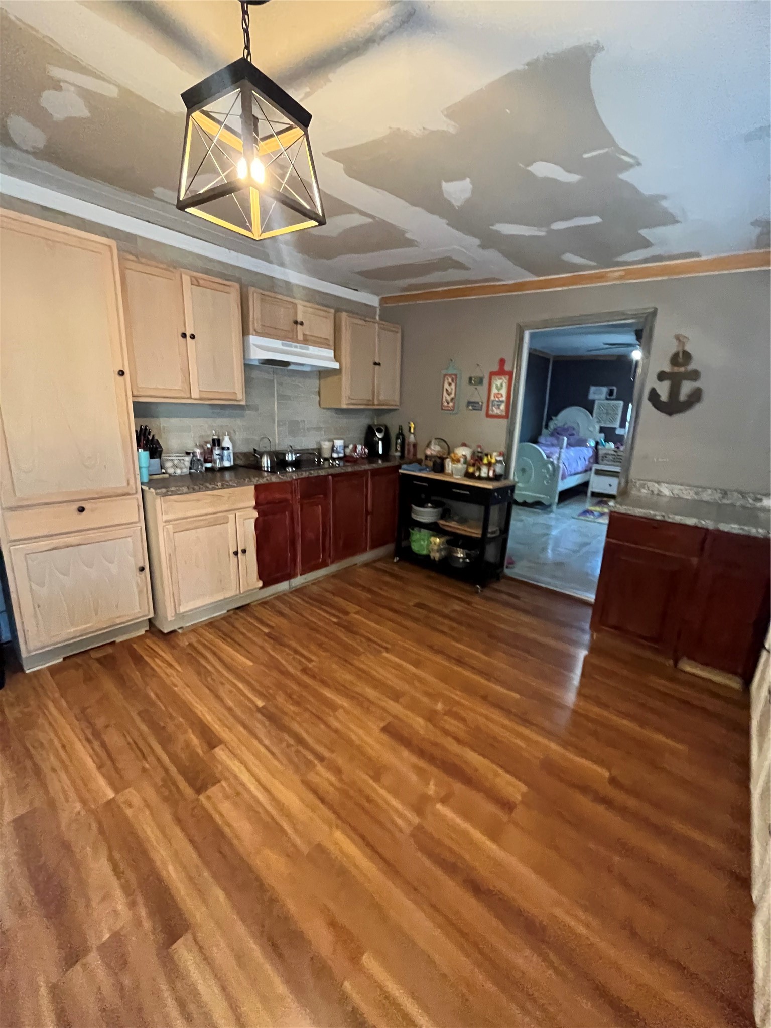 8026 Forest Trace Conroe, TX 77306 - Photo 12 of 28 a kitchen with stainless steel appliances granite countertop a sink dishwasher and a stove with wooden floor