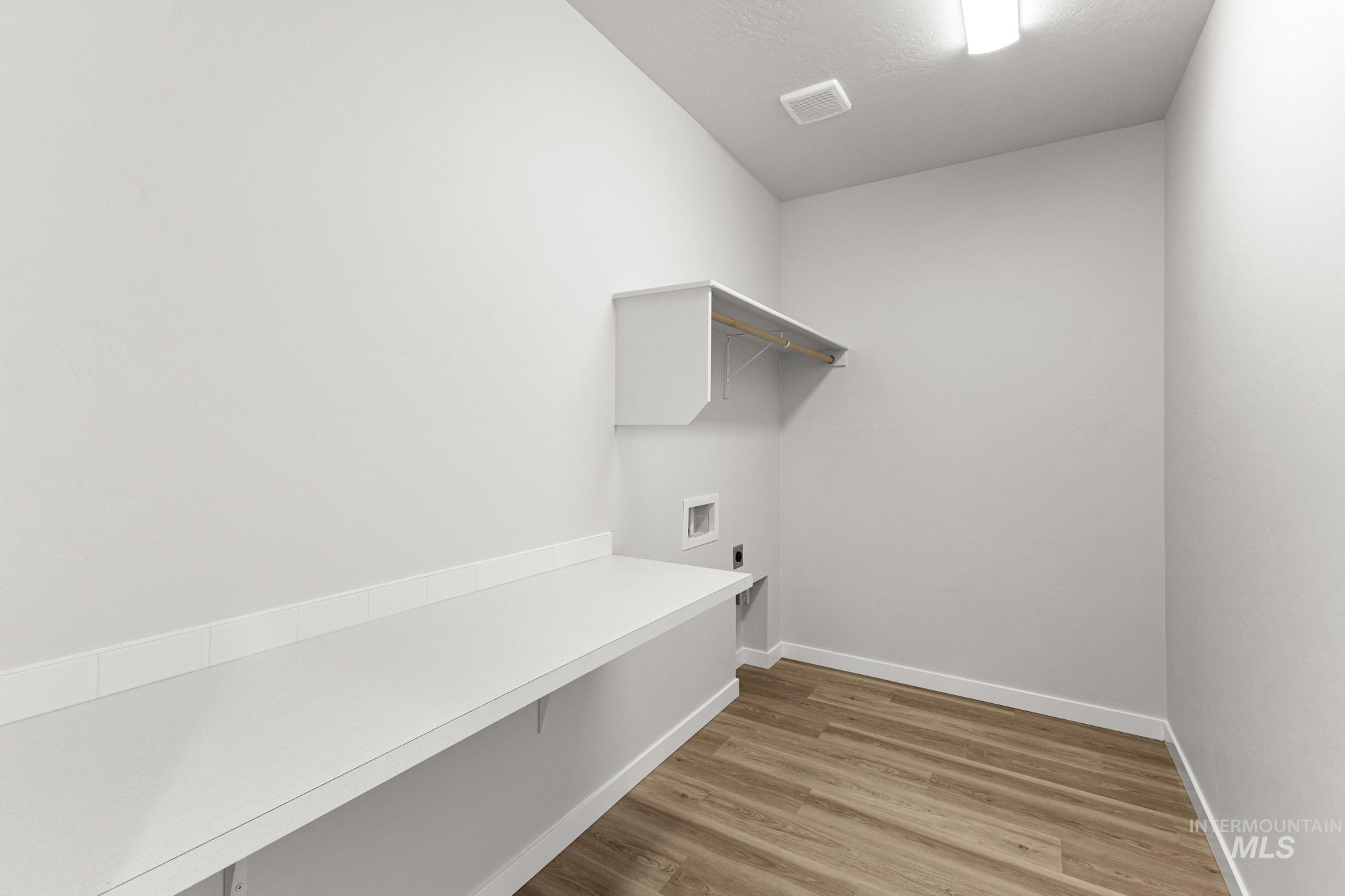 13708 Judson Street Caldwell, ID 83607 - Photo 20 of 29 Laundry room featuring light wood-style flooring and electric dryer hookup