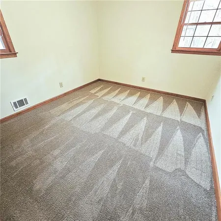 a view of empty room with windows