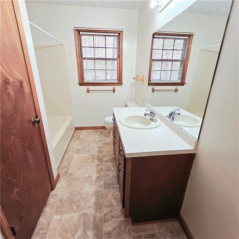 1955 Morgan Trace Canton, GA 30115 - Photo 10 of 17 a bathroom with a sink a vanity and a bathtub