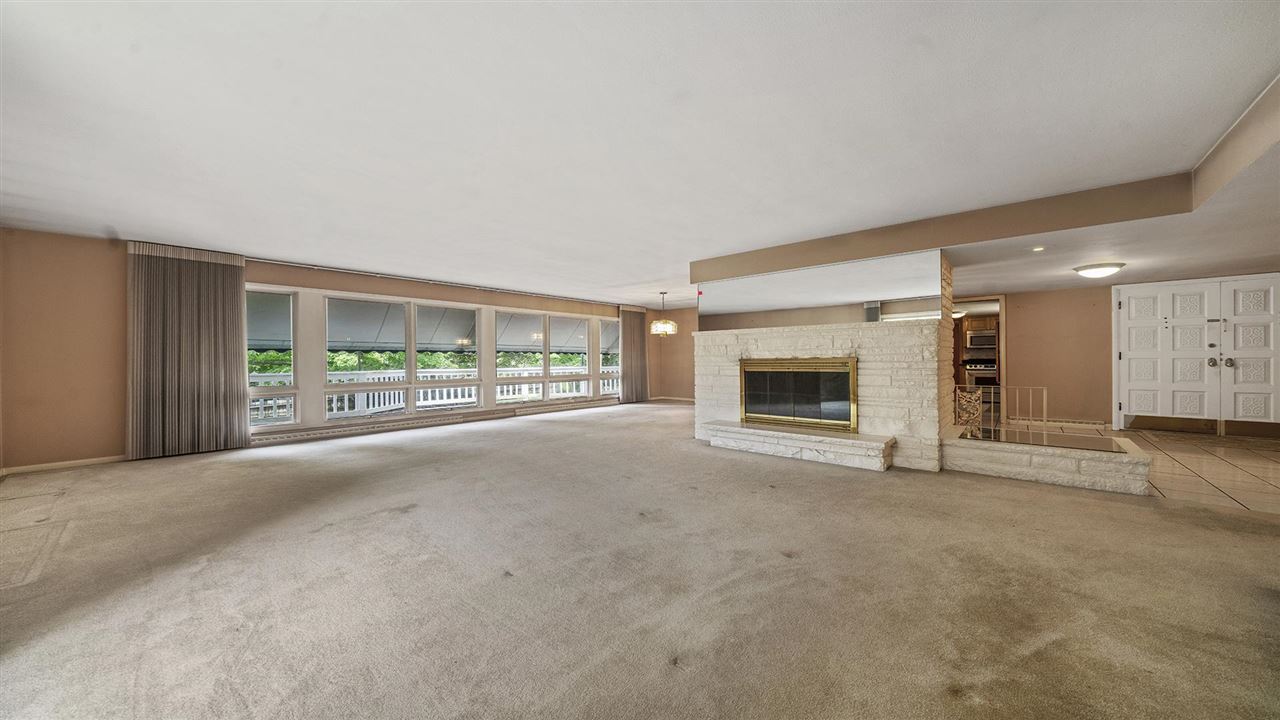 4114 Landstrom Road Rockford, IL 61114 - Photo 14 of 38 a view of an empty room with a fireplace and a window