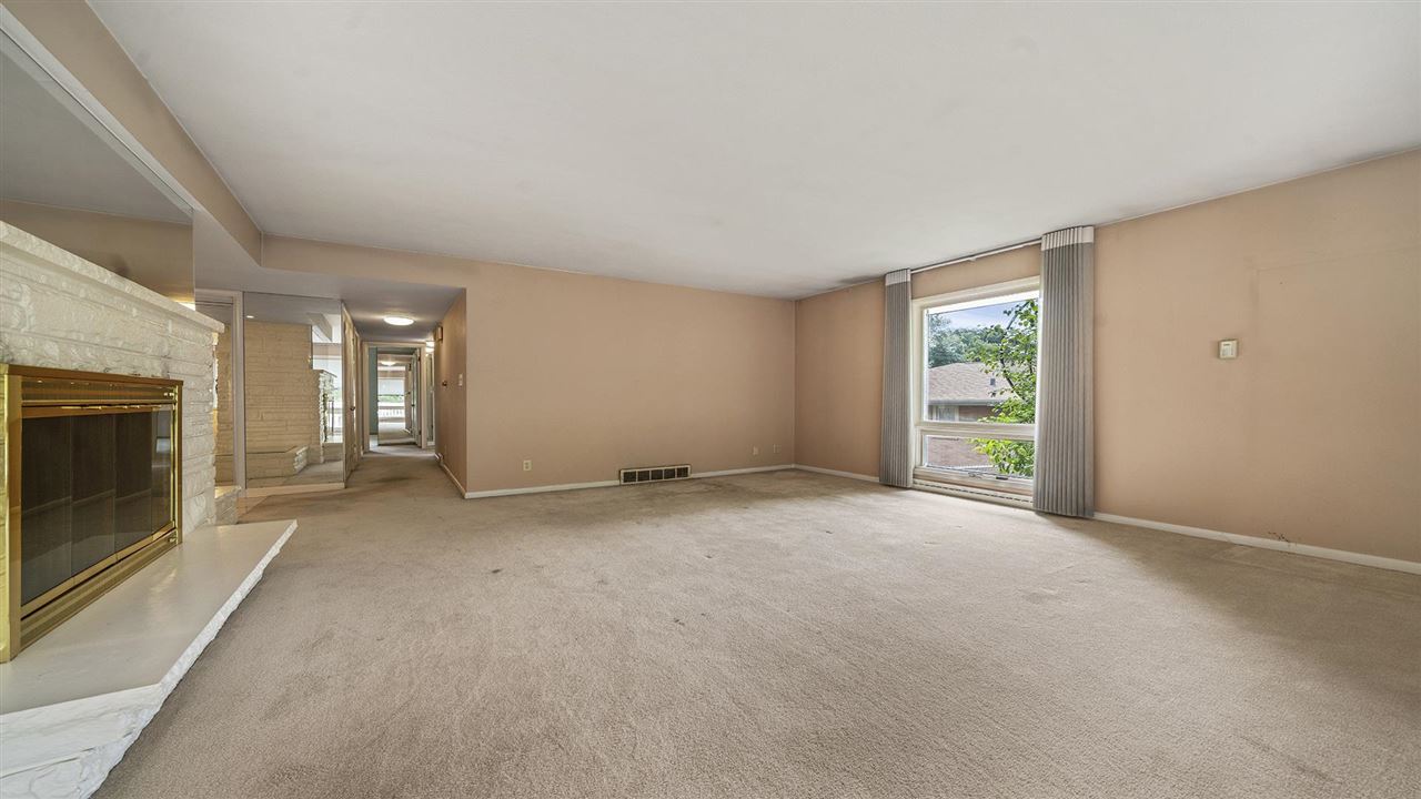 4114 Landstrom Road Rockford, IL 61114 - Photo 15 of 38 a view of an empty room with a fireplace and a window