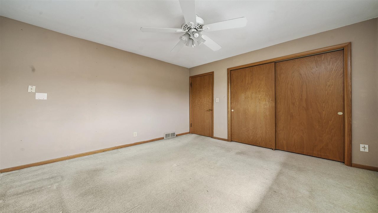 4114 Landstrom Road Rockford, IL 61114 - Photo 21 of 38 an empty room with a ceiling fan and a window