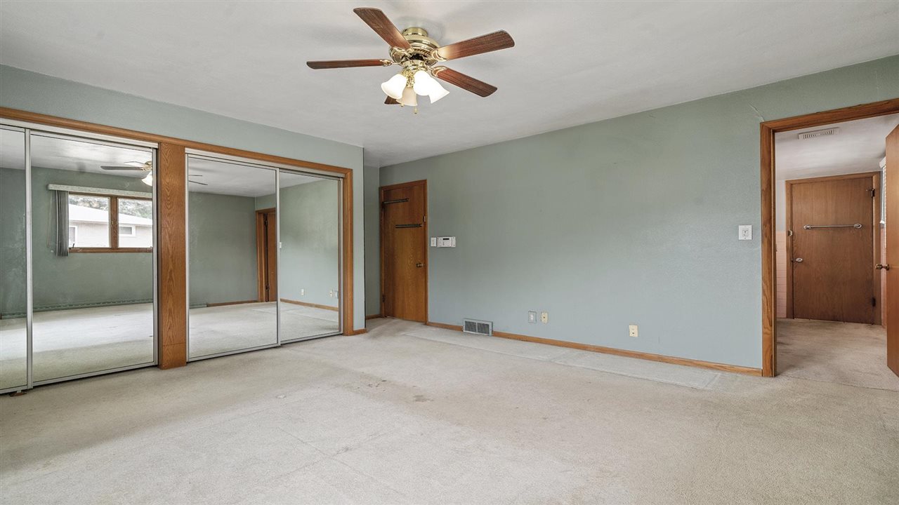4114 Landstrom Road Rockford, IL 61114 - Photo 23 of 38 an empty room with fan and windows