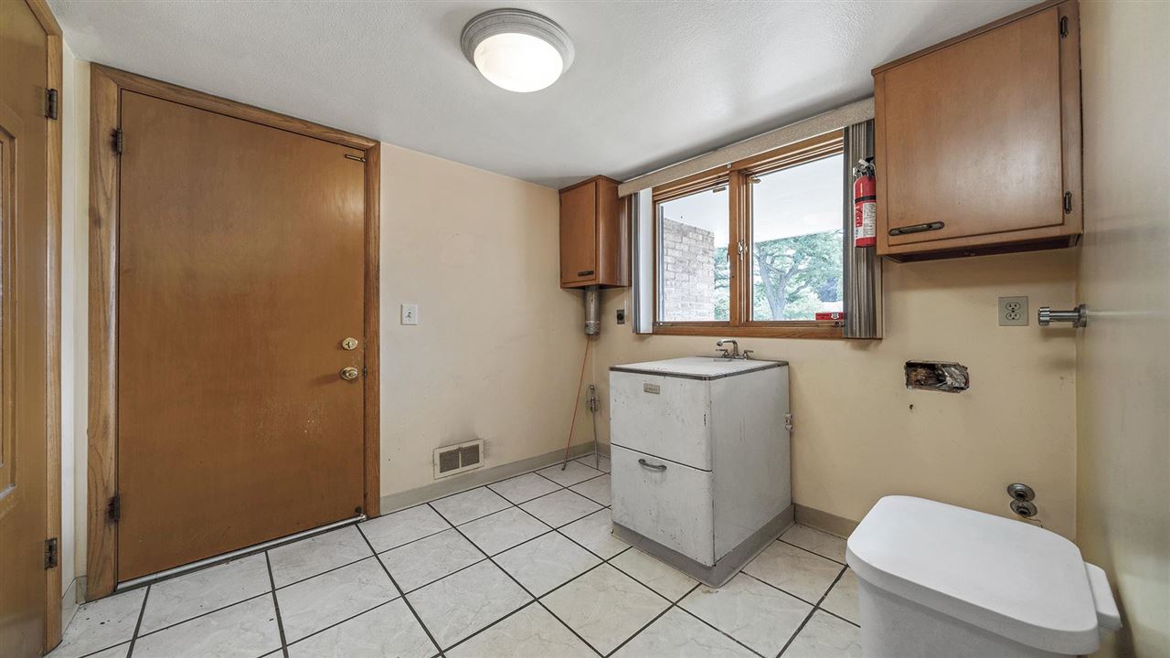 4114 Landstrom Road Rockford, IL 61114 - Photo 25 of 38 a bathroom with a sink a toilet and a shower
