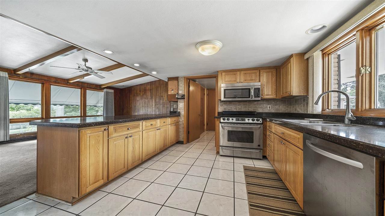 4114 Landstrom Road Rockford, IL 61114 - Photo 8 of 38 a kitchen with stainless steel appliances granite countertop a stove and cabinets
