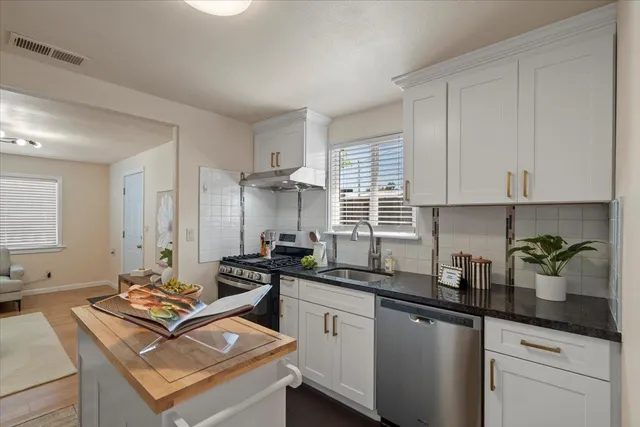 a kitchen with a sink stove and cabinets
