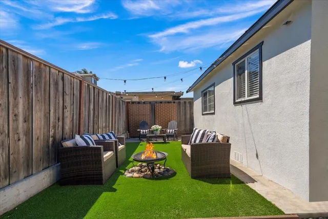 a view of a backyard with couches and a patio