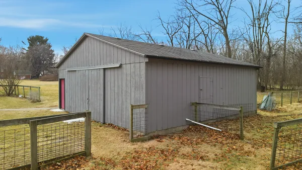 a backyard of a house with wooden fence