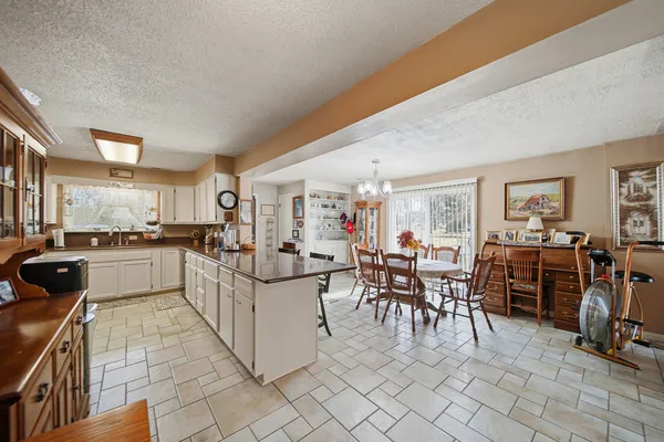 a living room with furniture a fireplace and a chandelier