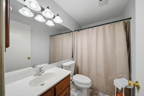 a spacious bathroom with a shower toilet and sink