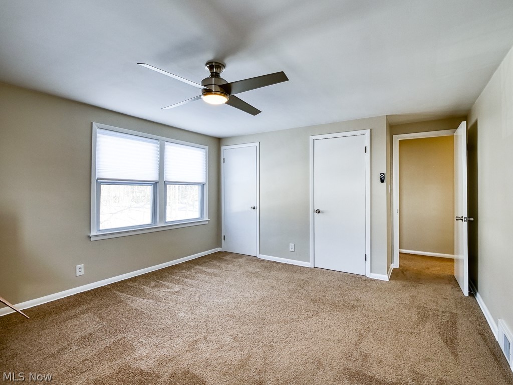 3844 Severn Road Cleveland Heights, OH 44118 - Photo 26 of 35 Second bedroom offers two closets, new ceiling fan light, neutral wall color and newer carpeting.