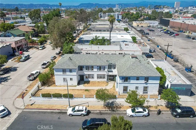 an aerial view of multiple houses with a street