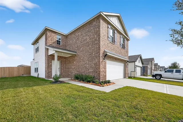 a view of a house with a yard and fence