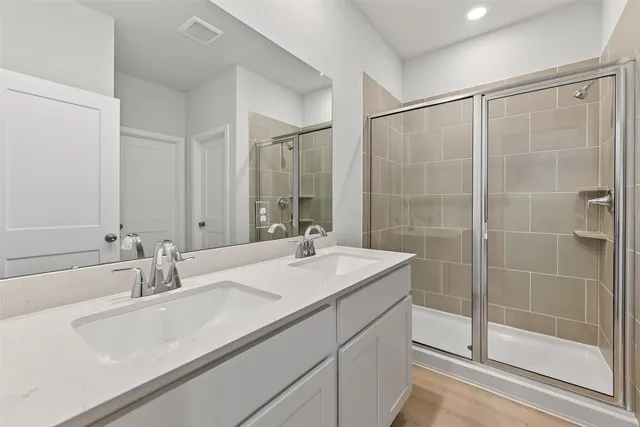 a bathroom with a glass shower door