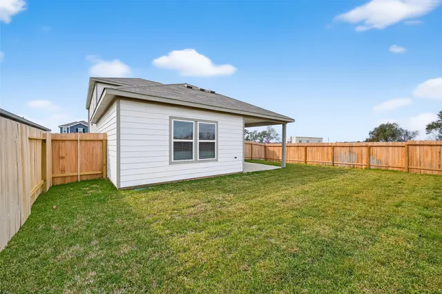 a view of a house with a backyard