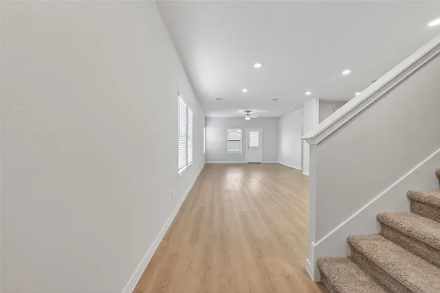 a view of entryway and hall with wooden floor