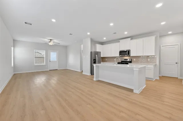 a view of kitchen with cabinets and wooden floor