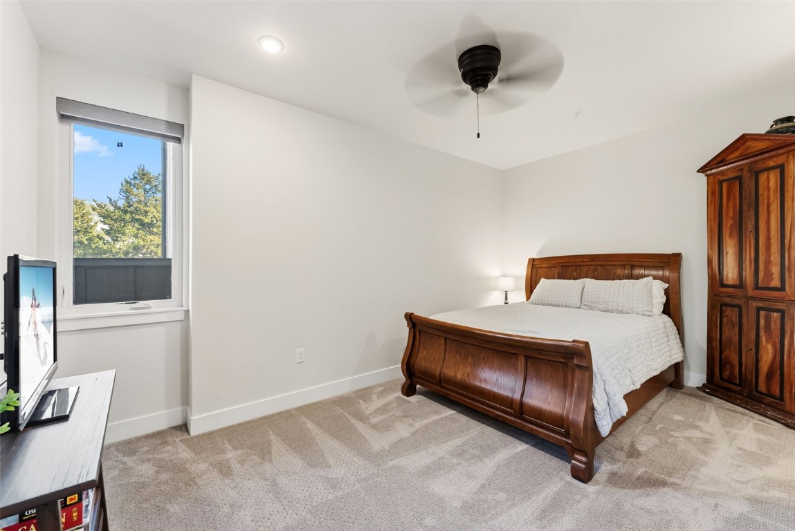 235 La Bonte Street, Unit 106 Dillon, CO 80435 - Photo 11 of 37 a bedroom with a bed and a flat tv screen on the wall