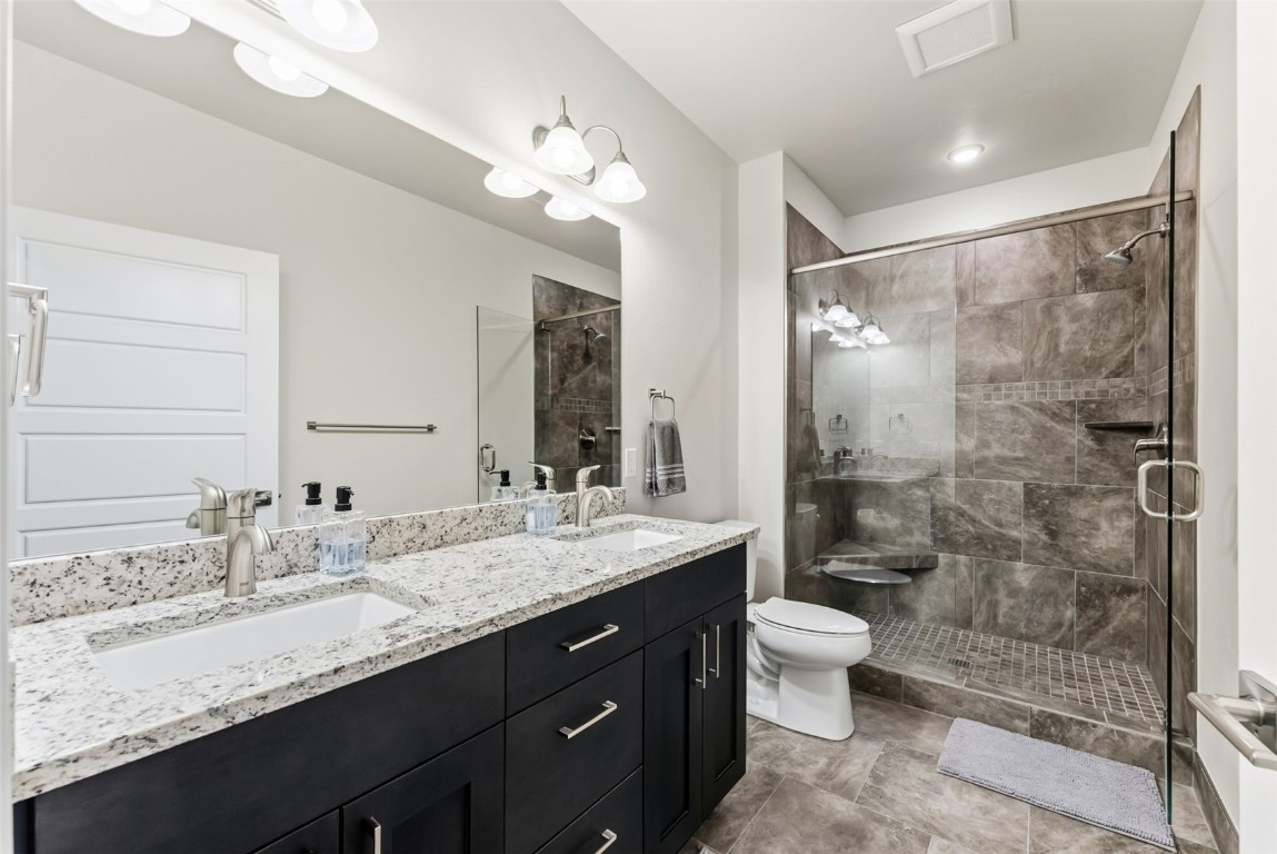 235 La Bonte Street, Unit 106 Dillon, CO 80435 - Photo 13 of 37 a bathroom with a granite countertop sink a toilet a mirror a vanity and shower