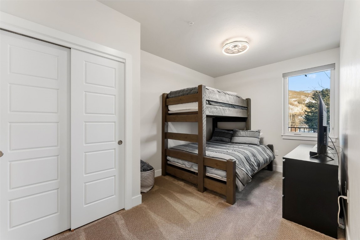 235 La Bonte Street, Unit 106 Dillon, CO 80435 - Photo 16 of 37 a bedroom with a bed and wooden floor