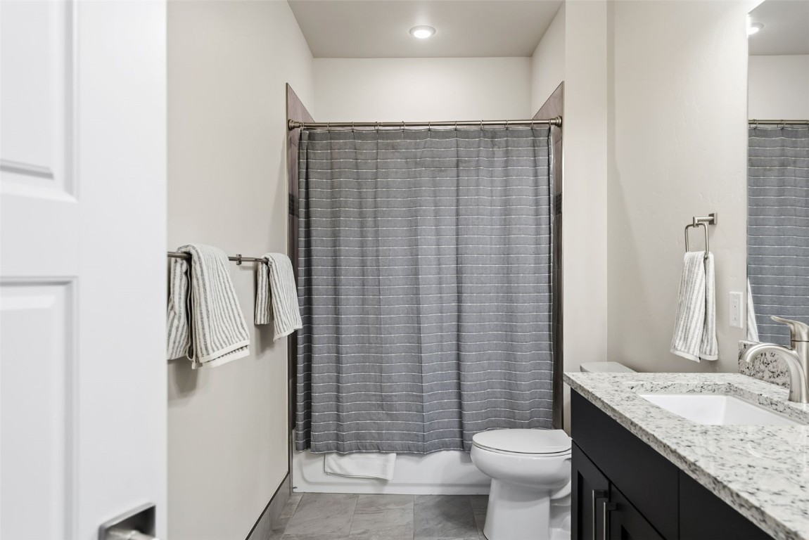 235 La Bonte Street, Unit 106 Dillon, CO 80435 - Photo 26 of 37 a bathroom with a granite countertop sink toilet and shower