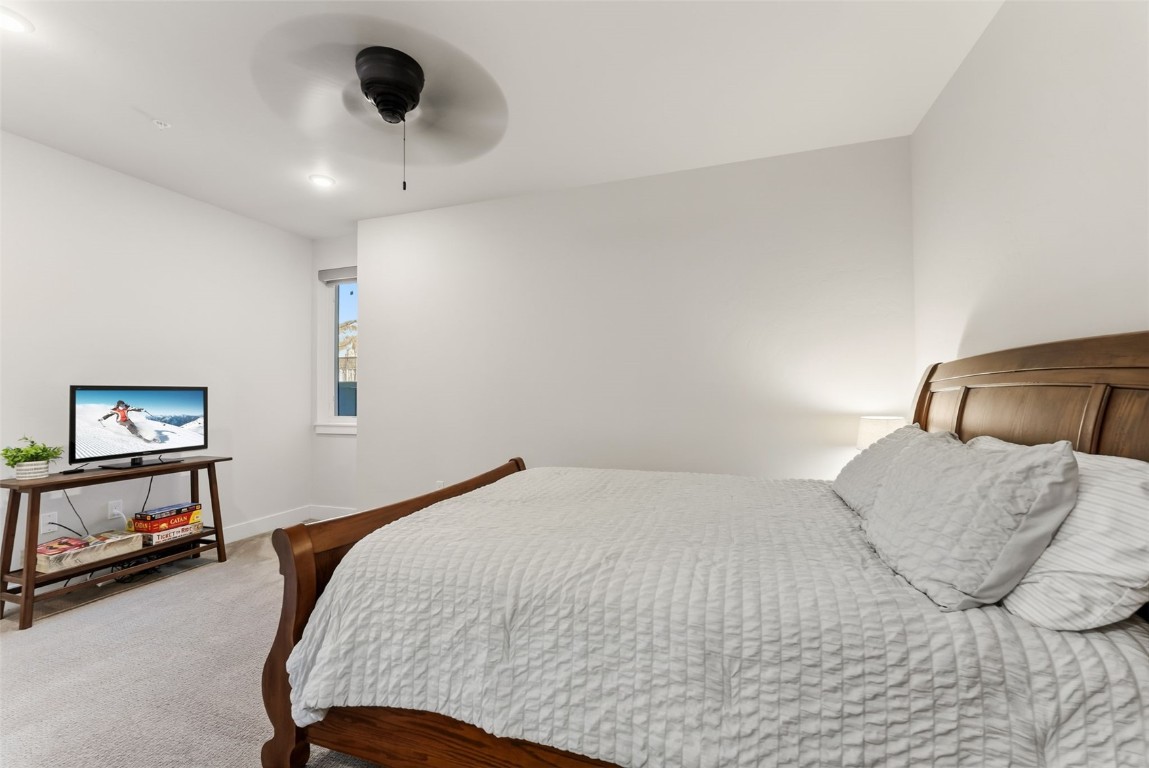 235 La Bonte Street, Unit 106 Dillon, CO 80435 - Photo 28 of 37 a bedroom with a bed and a large mirror