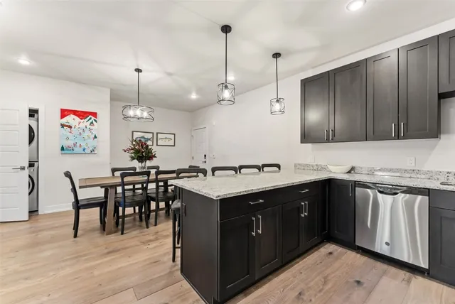 a kitchen with kitchen island a sink counter top space and appliances