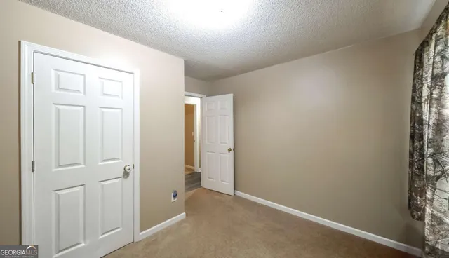 an empty room with closet area
