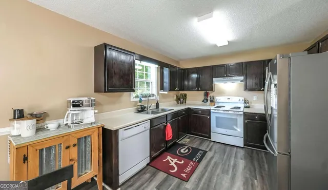 a kitchen with a sink stove and refrigerator