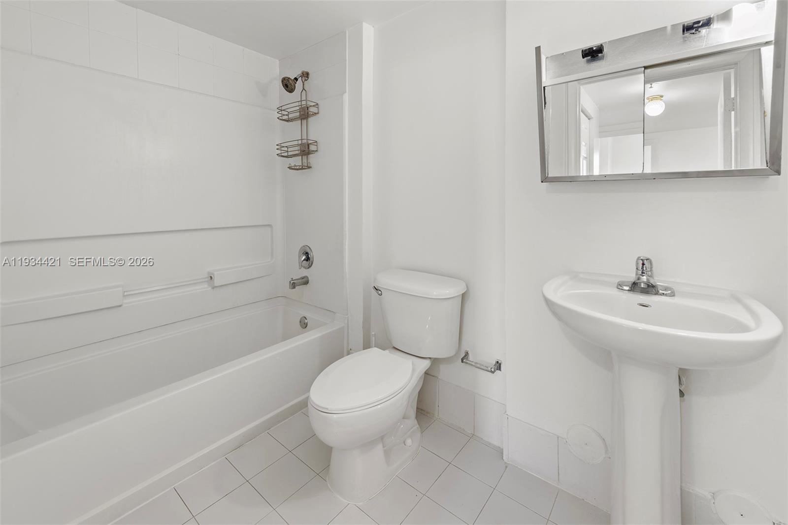 2217 Northwest 7th Street, Unit 902 Miami, FL 33125 - Photo 7 of 10 a bathroom with a toilet sink and mirror