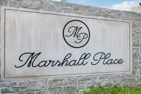 a white wall with a sign on it