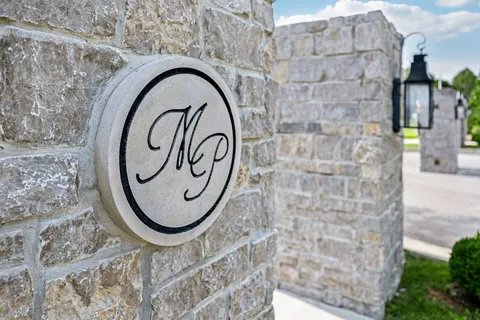 a picture of a brick wall with a potted plant on it