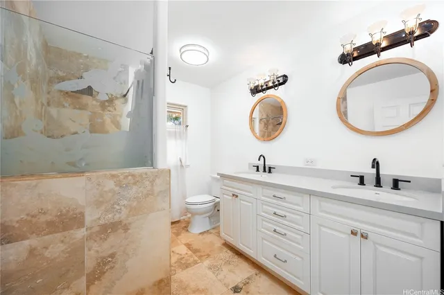 a bathroom with a toilet a sink and a mirror